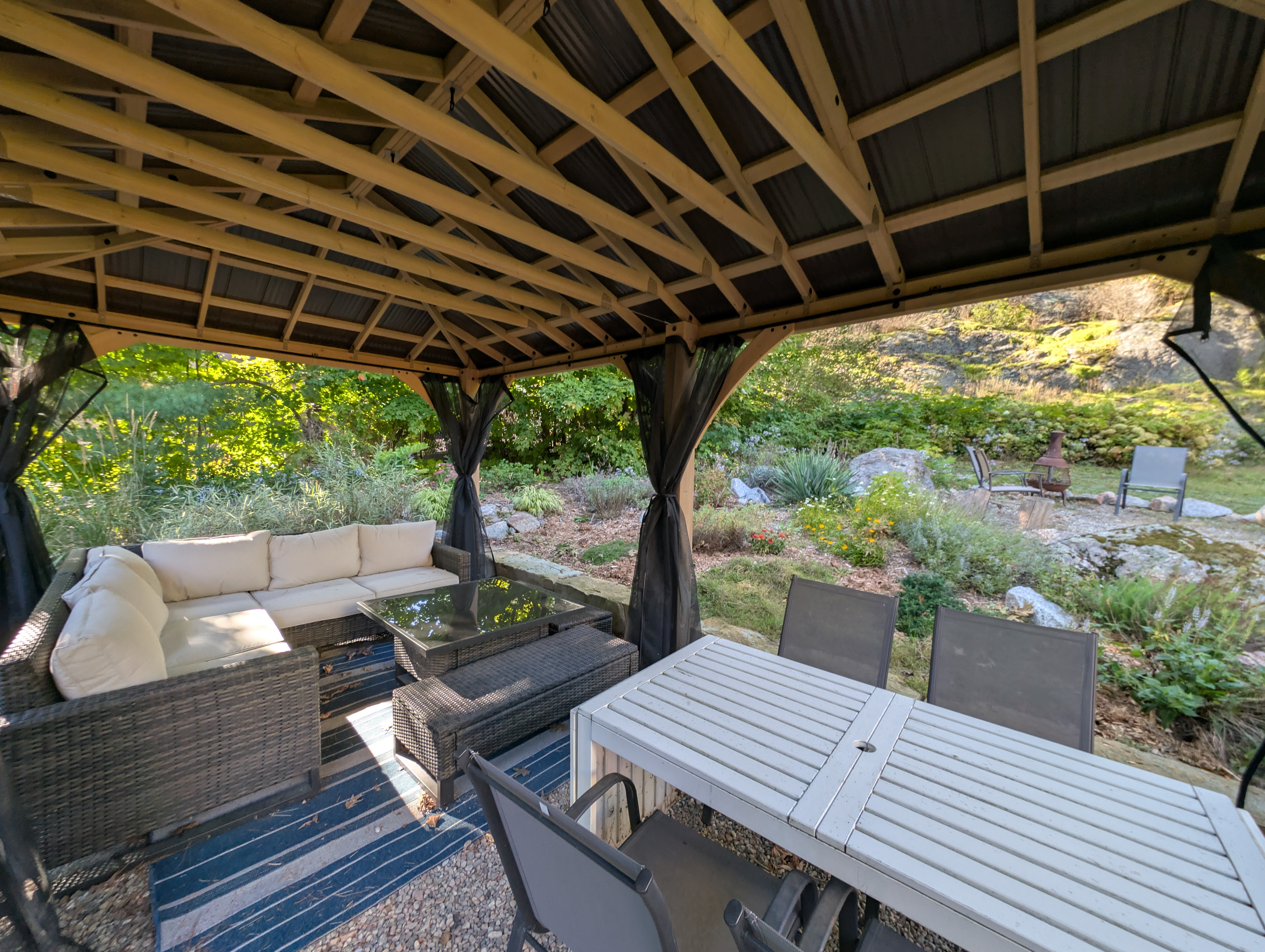 Covered gazebo with outdoor dining and lounge seating